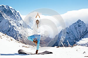 Yoga on mountain in winter