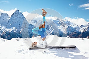 Yoga on mountain in winter