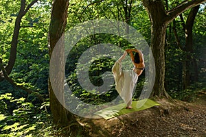 Woman doing yoga in the forest