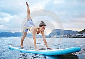 Yoga, ocean and woman balance on a surfboard for fitness on a holiday in Costa Rica. Stretching, training and girl doing