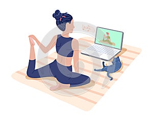 Yoga online classes. Girl watching online sport tutorials on laptop and working out at home with a cat.