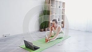 yoga online indoors activity woman laptop gym