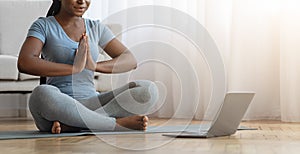 Yoga Online. Unrecognizable African Woman Practicing Meditation With Laptop At Home