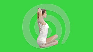 Yoga or pilates exercise without mat Gomukasana, Cow Face pose on a Green Screen, Chroma Key.