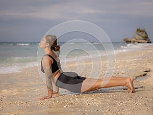 Yoga pose. Caucasian woman practicing Urdhva Mukha Svanasana, Upward-Facing Dog Pose. Strong body. Healthy lifestyle. Self-care