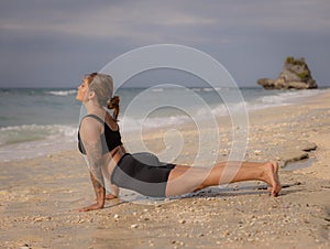 Yoga pose. Caucasian woman practicing Urdhva Mukha Svanasana, Upward-Facing Dog Pose. Strong body. Healthy lifestyle. Self-care