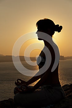 Yoga pose silhouette at sunrise