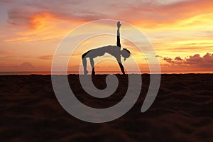 Yoga Poses. Woman Practicing Half Moon Asana On Ocean Beach. Female Silhouette Standing In Ardha Chandrasana At Beautiful Sunset.