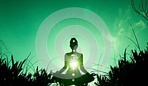 Yoga position silhouette in contrasting sun, Heart chakra