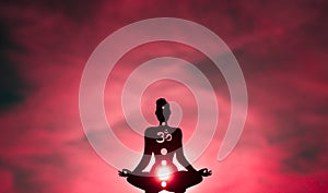 Yoga position silhouette in contrasting sun, Root Chakra photo