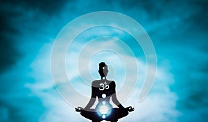 Yoga position silhouette in contrasting sun, Throat chakra photo