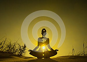 Yoga position silhouette in contrasting sun, Solar Plexus chakra photo