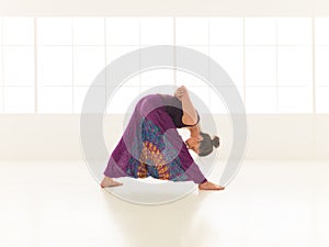 Yoga posture demonstration by young female instructor