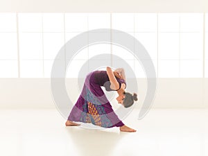 Yoga posture demonstration by young female instructor