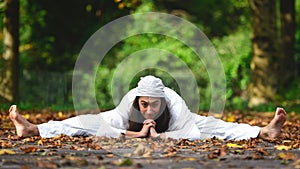 Yoga posture on the ground on the autumn leaves photo