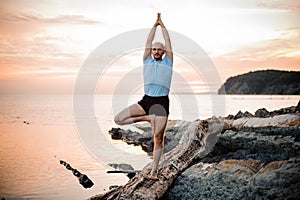 Yoga posture on sunset by man