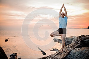 Yoga posture on sunset by man