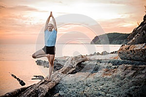 Yoga posture on sunset by man