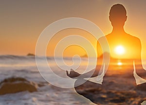 Yoga practice in the Lotus position on the beach in the sun