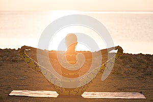 Yoga practice. Woman doing yoga pose at sunrise