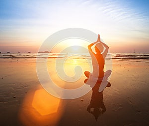 Yoga practicing at sunset.