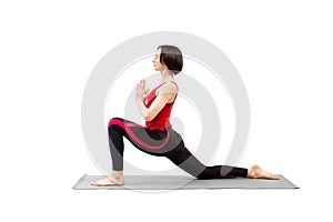 Yoga, riding posture. Attractive woman practice Ashva Sanchalanasana exercise with namaste hands at chest level