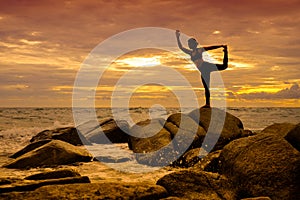 Yoga on the rock at the sunset with the murmur of waves.