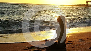 Yoga by sea and woman meditation in lotus position