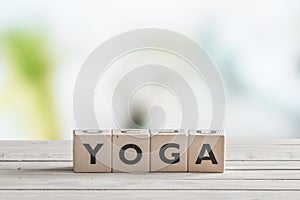 Yoga sign on a wooden desk