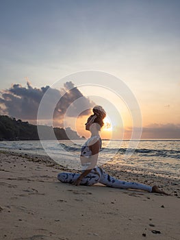 Yoga silhouette. Attractive woman practicing Ardha Kapotasana, Half Pigeon Pose. Chest opener improving breathing. Healthy