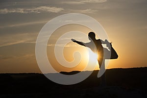 Yoga Silhouette meditation girl on the background of the sunset , fitness and healthy lifestyle