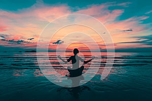 Yoga silhouette. Meditation girl on the sea during amazing sunset.