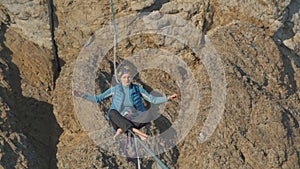 Yoga on a slackline stretched at a height.