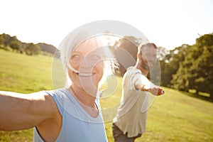 Yoga - something they both enjoy. Shot of a happy mature couple doing yoga together outdoors.