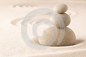 Yoga or spa wellness sandy background with round zen stone