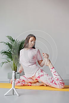 Yoga sports online at home. woman does sports and meditations at home, stretching