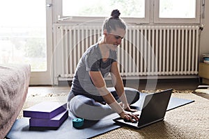 Yoga student doing online classes on laptop at home