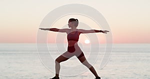 Yoga, sunset and a woman at the beach for fitness, wellness and training in peace. Exercise, ocean and a young girl at