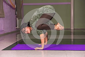 Yoga teacher showing yoga asana in fitness class