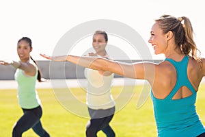 Yoga teacher and sporty women attending yoga class