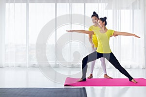 Yoga teachers are teaching exercise yoga for students. With the correct position Inside the room for good health and flexibility