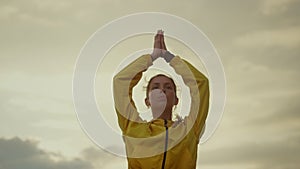 Yoga trainer meditating in tree pose. Sports woman exercising yoga in mountains