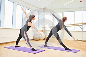 Yoga training. Instructor and woman doing excercise