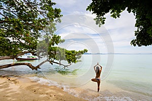 Yoga on tropical thai beach photo