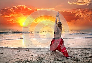 Yoga virabhadrasana warrior pose at sunset