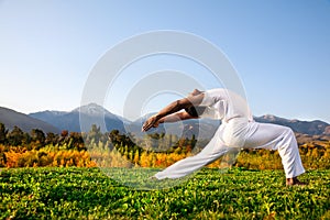 Yoga warrior pose in mountains