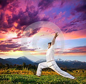 Yoga warrior pose in mountains