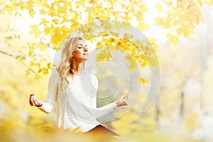 Yoga woman in autumn park