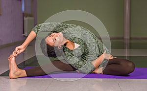 Yoga woman does exercises yoga in fitness class