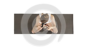 Yoga woman doing make up while sitting in lotus pose on white background.